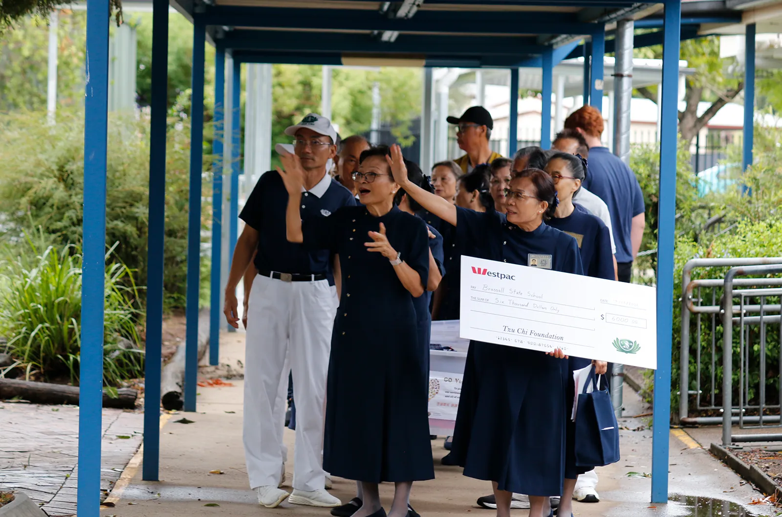 Scholarship Program – Volunteers Lining Up to Enter Brassall State School (Photo by Becky Hesketh)