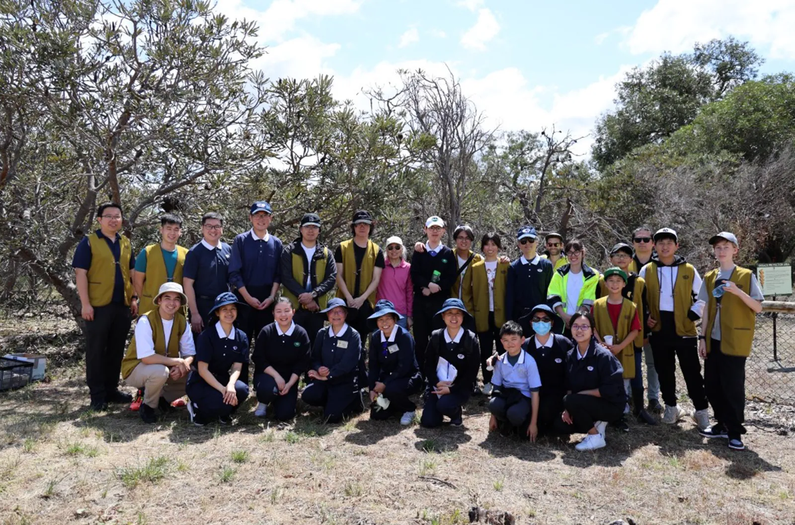 Pulling Weeds - Group photo of volunteers participating in the activity